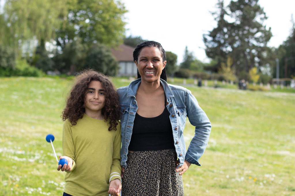 Mother and daughter standing on a lawn